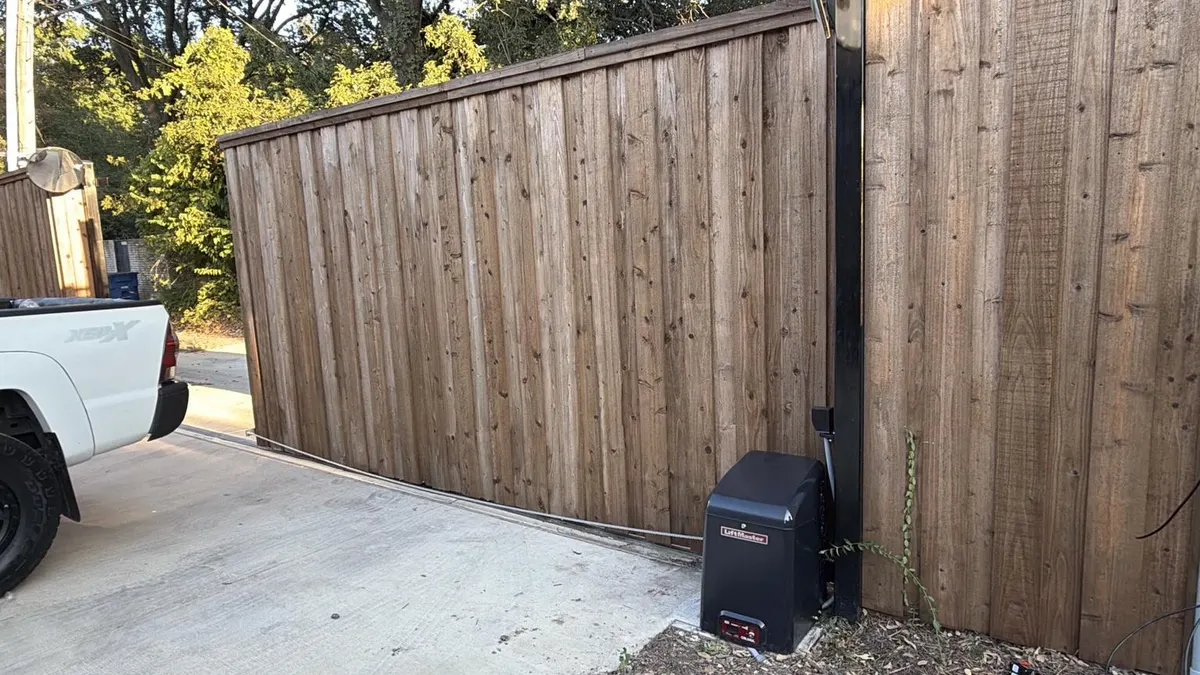 Wide view of the wooden sliding gate and installed CSL24UL.