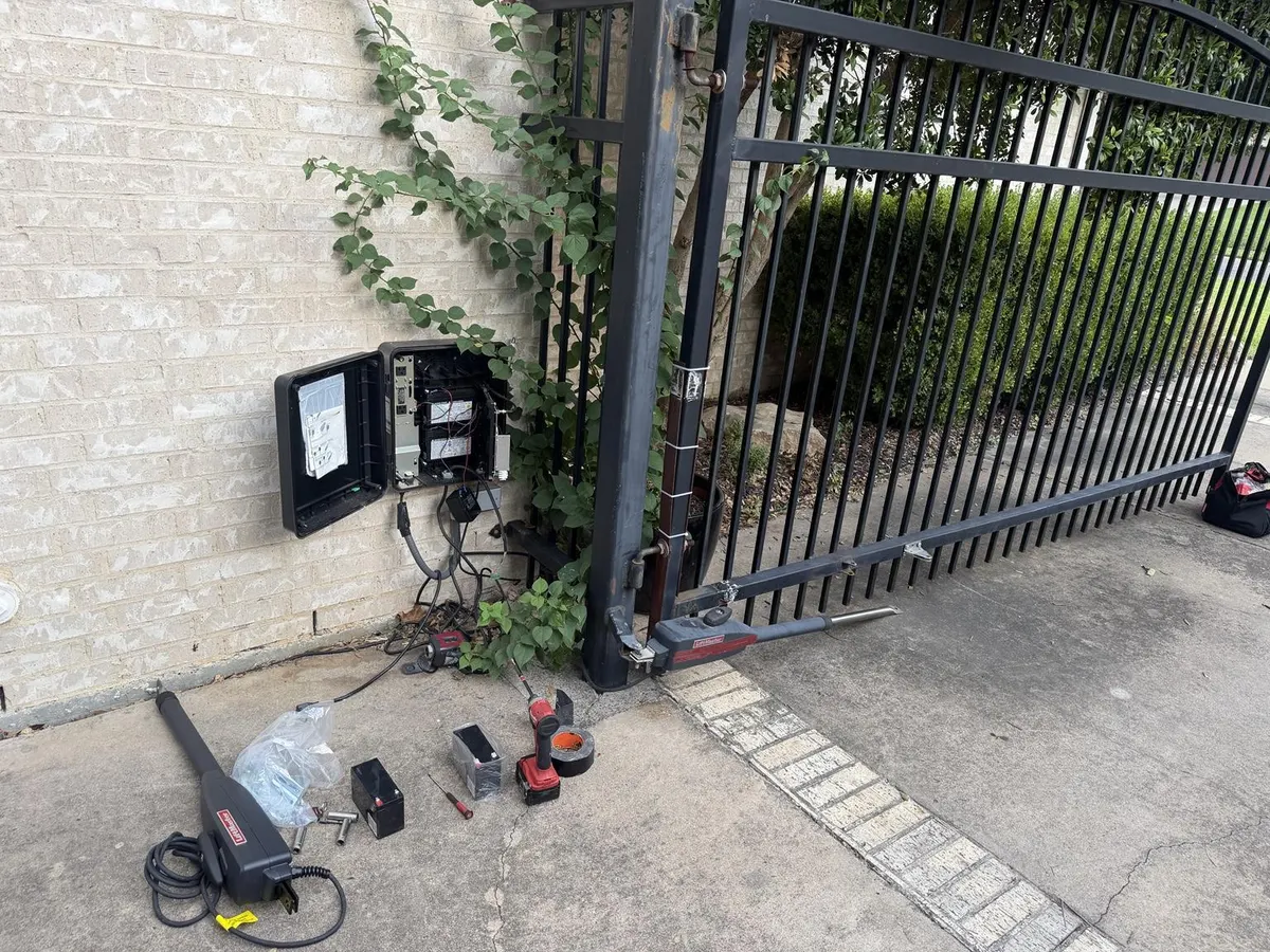 Gate and control enclosure during the repair, with an operator arm removed.