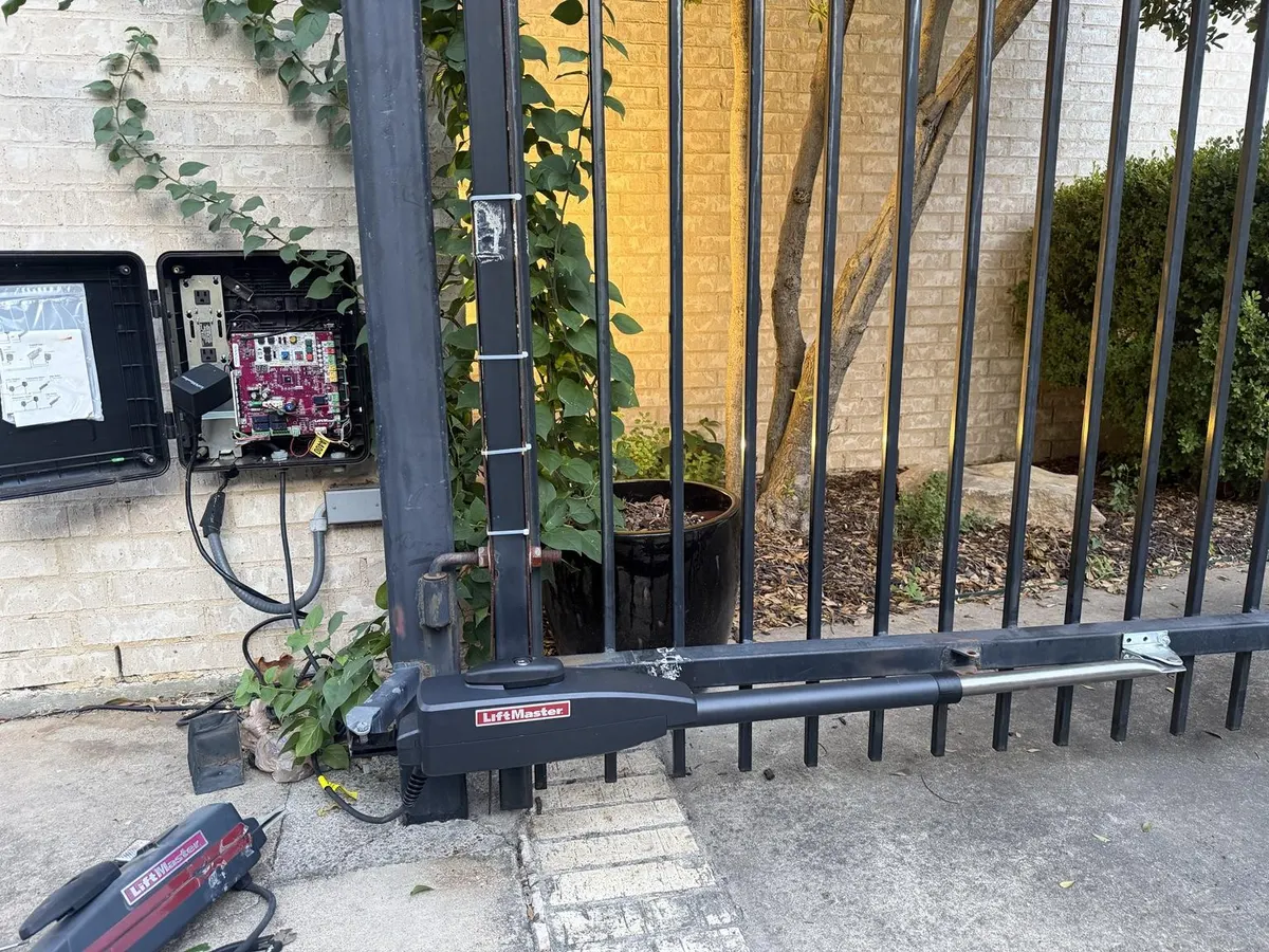 Replacement LiftMaster arm mounted on the swing gate.