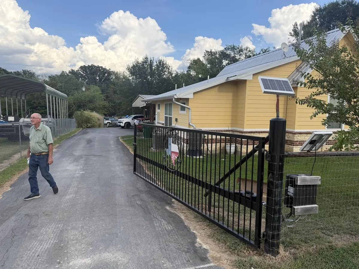 Additional view of the driveway and gate opening.