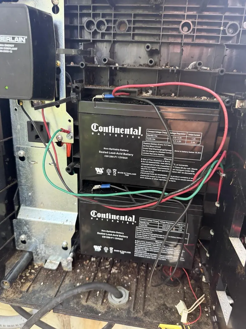 Backup battery compartment and debris inside the enclosure.